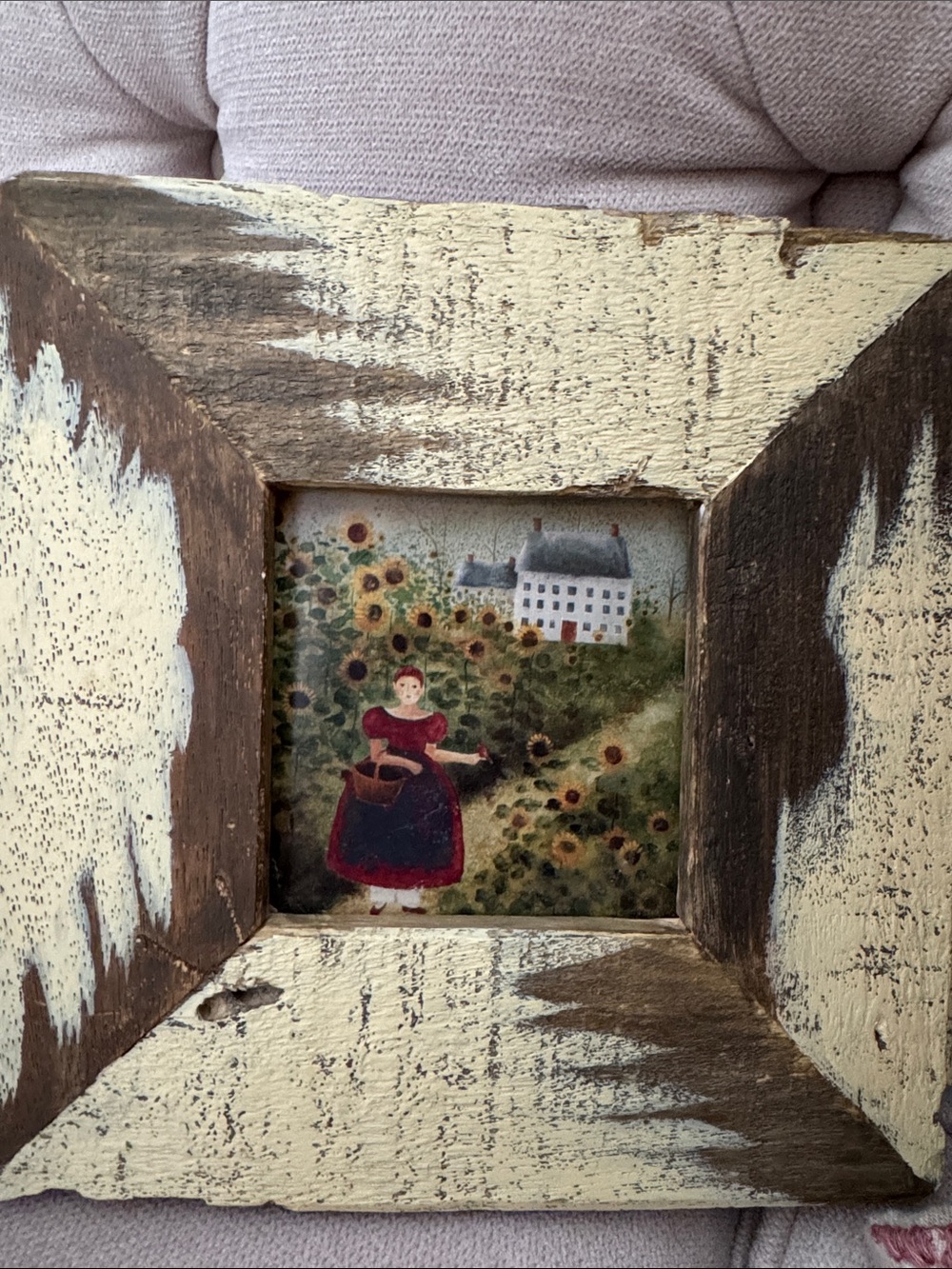 “Anna’s Field" by artist Carol Endres, set in a chunky, distressed wood frame